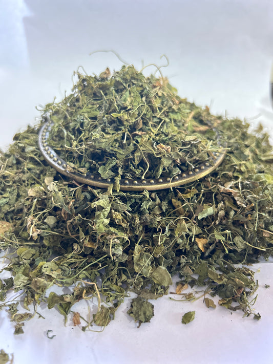 A pile of fresh green fenugreek herbs (Kasuri Methi) arranged on a clean white surface.